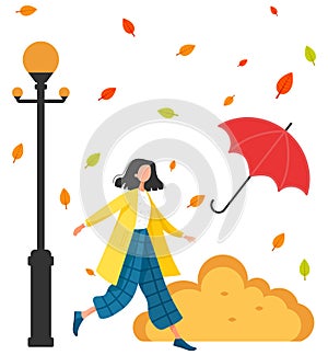 Young woman is walking under an umbrella in rain. Girl is wearing coat. Lifestyle in autumn concept