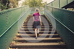 Young woman walking up stairs