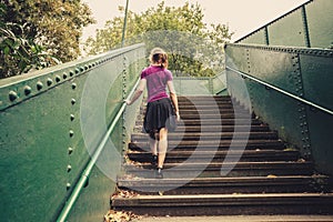 Young woman walking up stairs