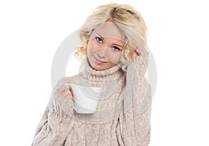 Young woman in a warm sweater and a mug in his hands