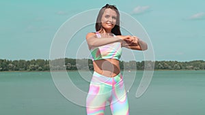 Young woman warming up during exercising at sport playground outdoor