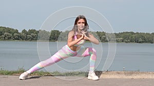 Young woman warming up during exercising at sport playground outdoor