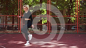 Young Woman Warming Up for Fitness on Court