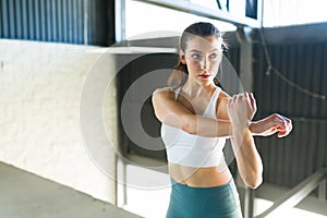 Young woman warming up to start a HIIT routine