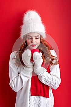 young woman warms up drinking hot beverage