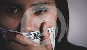 Young woman was wrapping her mouth by money, Concept freedom of speech, censorship, freedom of press. International Human Right