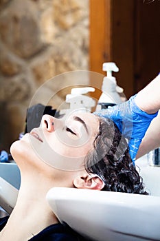 Young woman wash hair at hairdreser