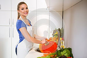 Young woman washing dishes