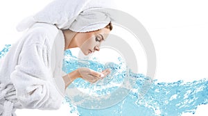 Young woman washing face with clean water.