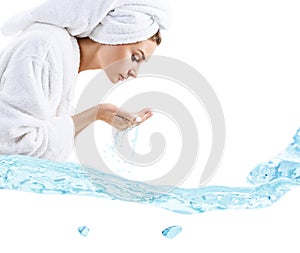 Young woman washing face with clean water.