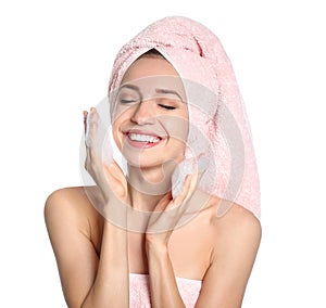 Young woman washing face with soap foam on white background