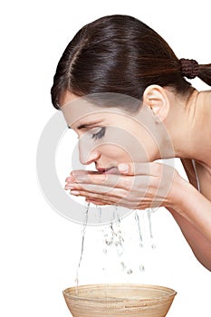 Young Woman Washing Her Face With Water