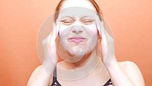 Young woman washing scrubbing face with facewash soap scrub. 4K UHD