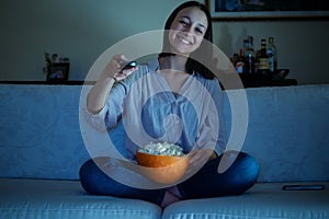 Young woman watching her favorite program on tv photo