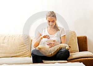 Young woman watching TV and eating chips