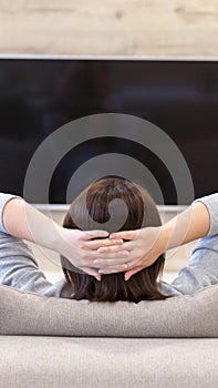 Young woman watching TV in the room