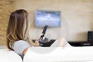 Young woman watching TV