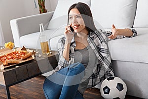 Young woman sport fan watching match phone call