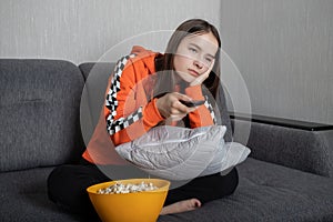 Young woman watching an uninteresting TV show