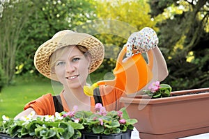 Young woman watering flowers