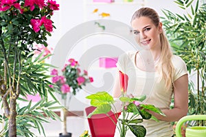 The young woman watering plants in her garden
