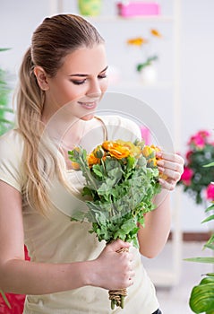 Young woman watering plants in her garden