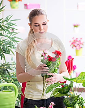 Young woman watering plants in her garden