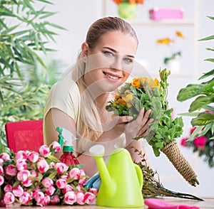 Young woman watering plants in her garden