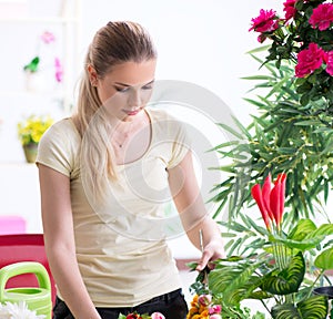 Young woman watering plants in her garden