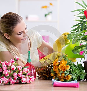 Young woman watering plants in her garden