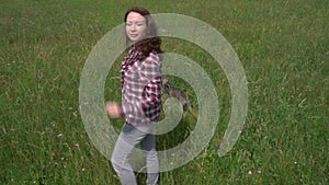 Young woman wear jeans and checkered shirt walking in nature outdoor