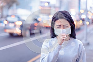 Young  woman wear mask in the city during Smog day