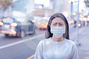 Young  woman wear mask in the city during Smog day photo