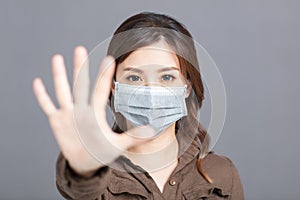 Young woman  wear medical mask and showing no and stop sign gesture. keep away, Social distance