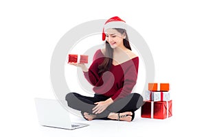 Young woman wear santa hat and gift box sitting labtop