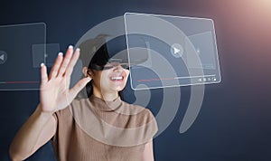 Young woman wear VR headset standing and watch movie at night