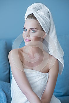 Young Woman Wearing Bath Towel Sitting on Sofa