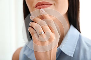 Young woman wearing beautiful engagement ring