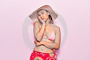 Young woman wearing bikini and hat thinking looking tired and bored with depression problems with crossed arms