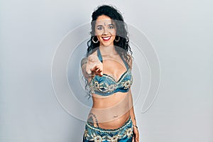 Young woman wearing bindi and traditional belly dance clothes smiling cheerful offering palm hand giving assistance and acceptance