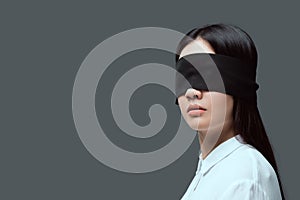 young woman wearing black blindfold photo
