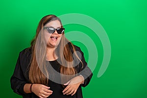 Young woman, wearing black glasses on   Green Background