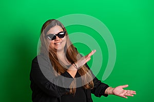 Young woman, wearing black glasses on   Green Background