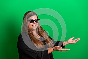 Young woman, wearing black glasses on   Green Background