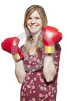 Young woman wearing boxing gloves smiling