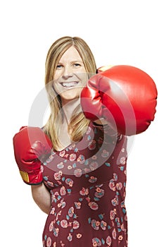 Young woman wearing boxing gloves smiling