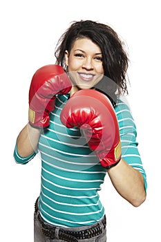 Young woman wearing boxing gloves smiling