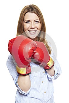 Young woman wearing boxing gloves smiling