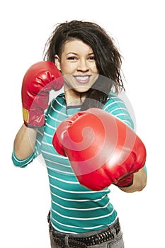 Young woman wearing boxing gloves smiling