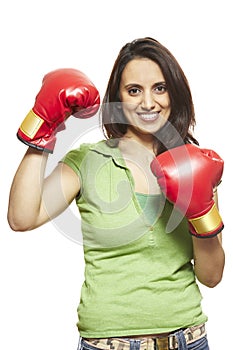 Young woman wearing boxing gloves smiling